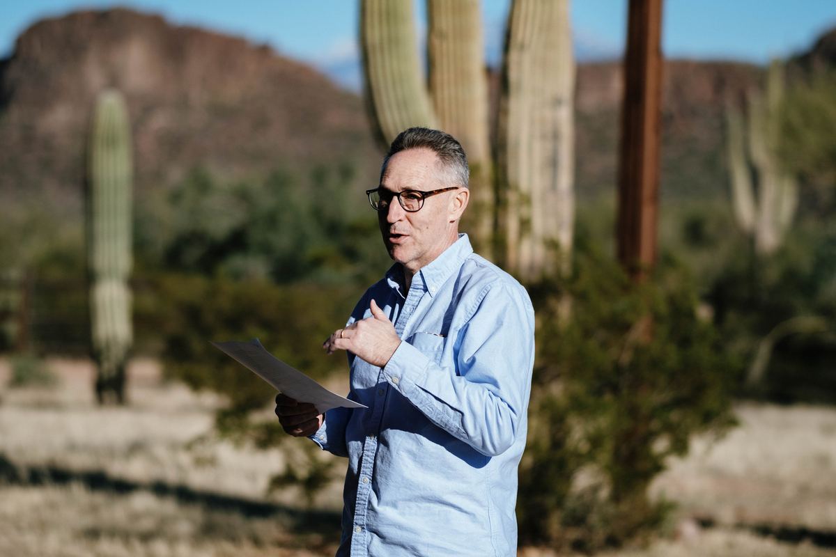 A participant reading a paper among saguaros