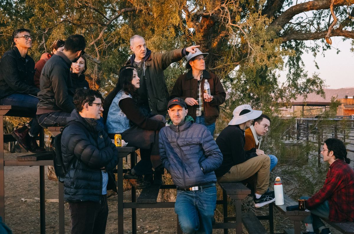 Participants in discussion under the trees