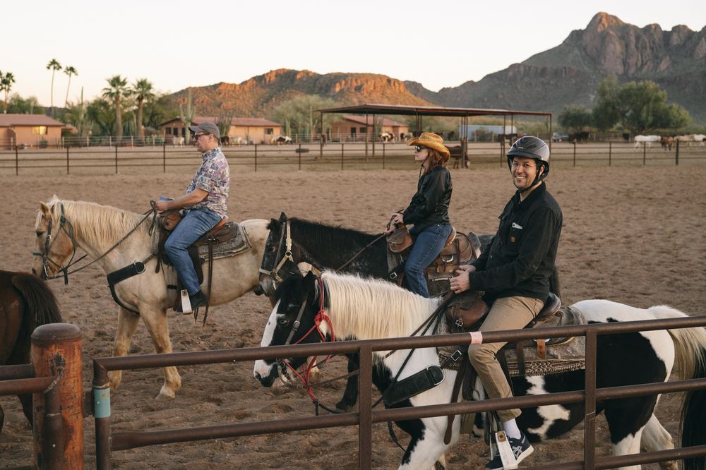 Riders in the corral at sunset